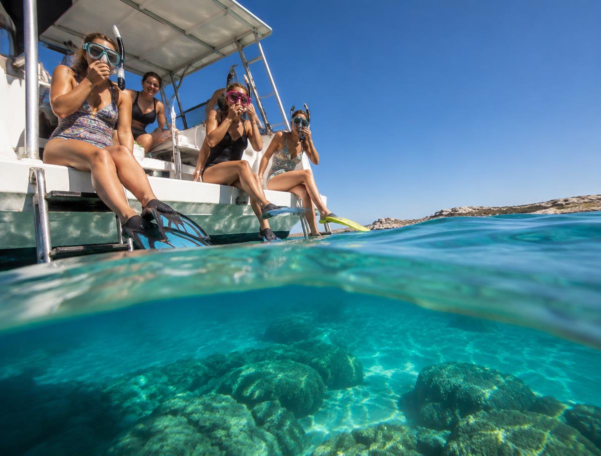 Women preparing to snorkel from an eco boat